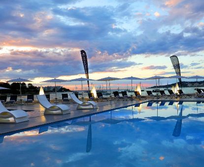 Preciosa zona exterior con amplia piscina, solarium y vistas de este hotel solo para adultos.