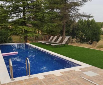 Foto del jardín con piscina privada y solarium de esta casa rural.