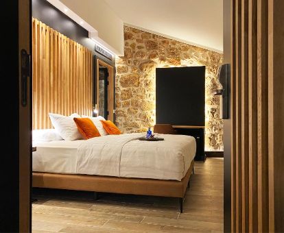 Una de las elegantes habitaciones con paredes de piedra a la vista del hotel.