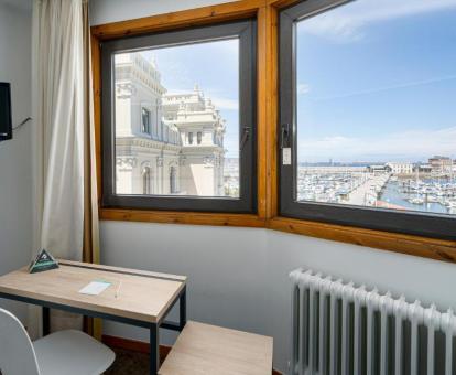 Foto de la ventana con vistas al mar y al puerto de una de las habitaciones.