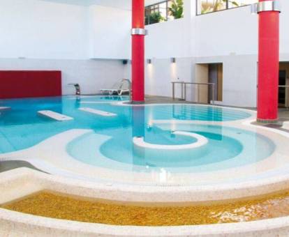 Fotod de la piscina con elementos de hidroterapia del spa.
