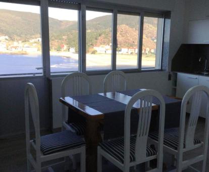 Foto del comedor con amplia cristalera y vistas al mar.