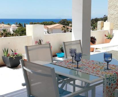 Foto de la maravillosa terraza con comedor exterior y vistas al mar de este apartamento.