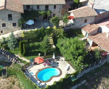 Piscina ovalada exterior ubicada al lado del jardín de la Casa Rural La Majada de Peñacorada