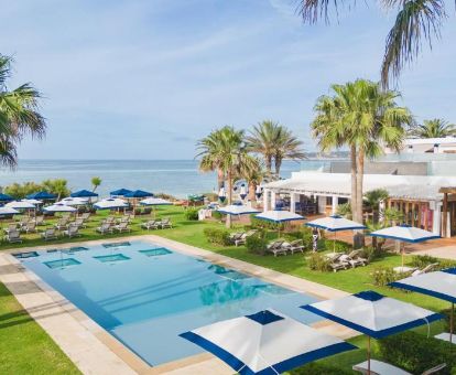 Amplia zona exterior con jardines, piscina y vistas al mar de este hotel solo para adultos.