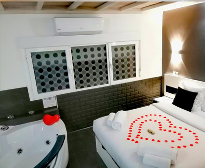 Foto de la habitación con balera de hidromasaje cerca de la cama en el apartamento Gredos Loft