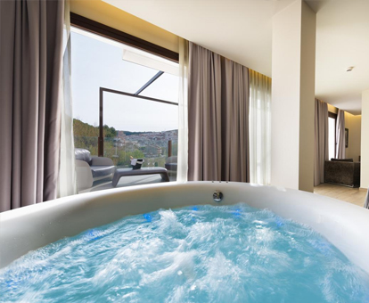 Foto del jacuzzi privado con chorros de agua y vistas a la campiña del Hotel Spa Elia