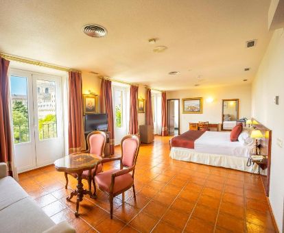 Amplia habitación de estilo tradicional con sala de estar de este hotel rural.