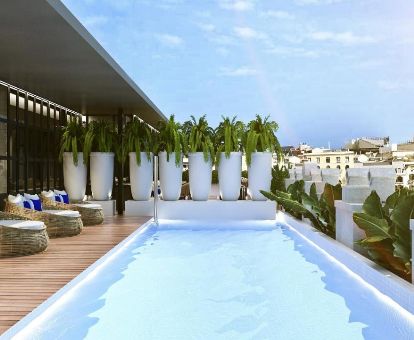 Terraza con mobiliario y piscina con vistas de este romántico hotel ideal para parejas.