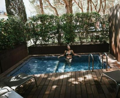Mujer disfrutando de la piscina privada de una de las suites del hotel.