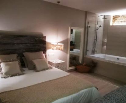 Foto de la Suite con bañera de hidromasajes junto a la cama.